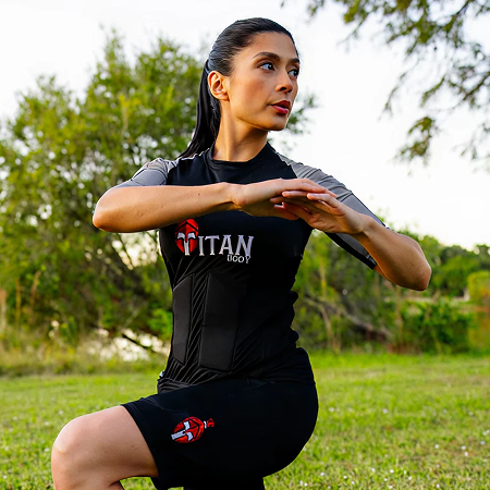 A woman doing workouts in a TitanBody suit, exhibiting EMS suit cost.