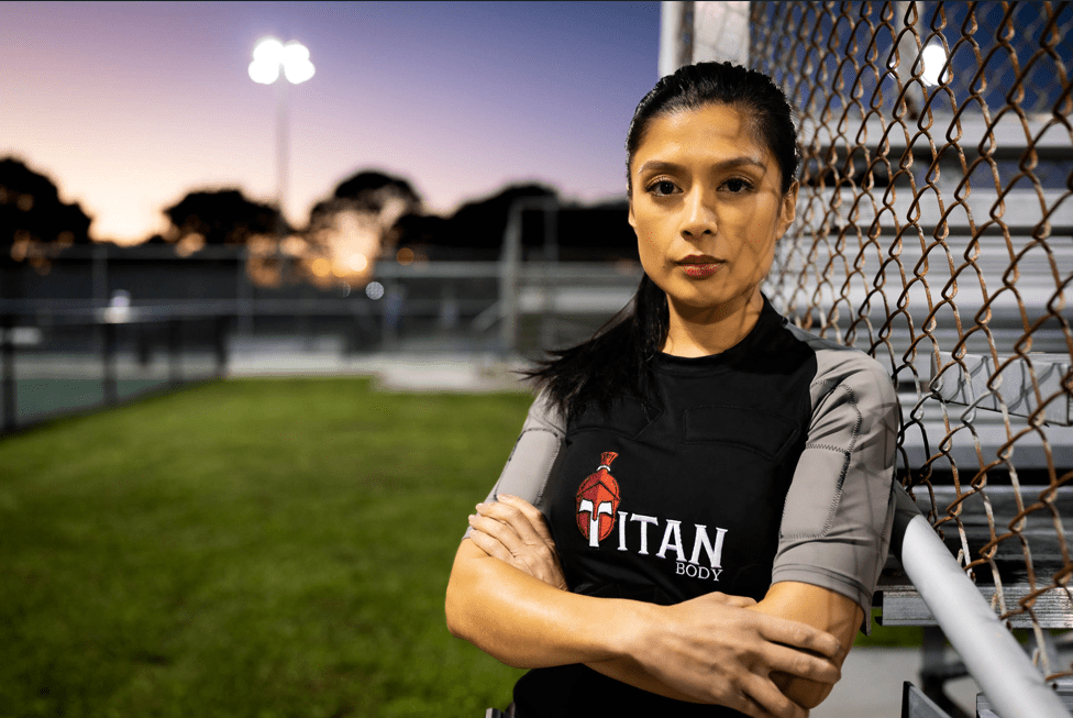 Woman wearing a TitanBody EMS suit , with her arms crossed outdoors