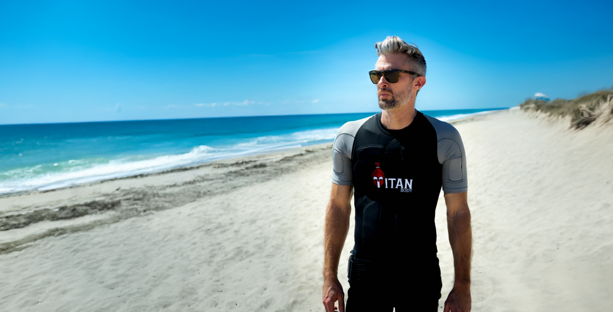A man in an original TitanBody suit while walking and strength training on Delray beach.
