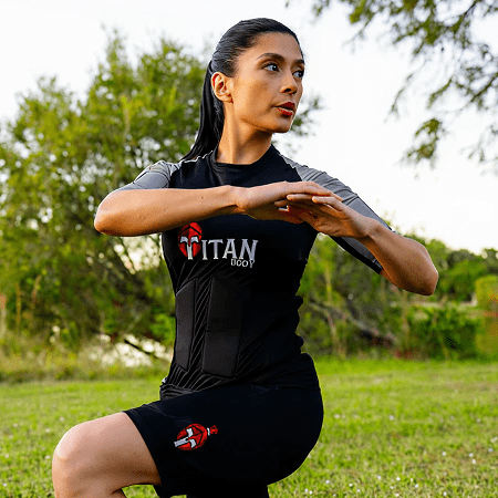 A woman doing workouts in a TitanBody suit, exhibiting EMS suit cost.